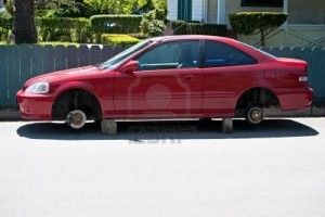 7498254-a-parked-automobile-on-blocks-whose-wheels-and-tires-have-been-stolen