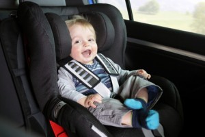 Baby boy in a child safety car seat